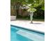 Close up of a statue next to a swimming pool, hot tub and white tile surrounding it at 2050 Wappoo Hall Rd, Charleston, SC 29412