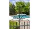 Close up of an ornate iron gate near a swimming pool, hot tub, and lush landscaping at 2050 Wappoo Hall Rd, Charleston, SC 29412