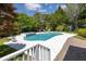 Backyard view of pool and hot tub with a lush yard including a shed surrounded by mature landscaping at 2050 Wappoo Hall Rd, Charleston, SC 29412