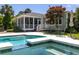 Backyard pool with spa and outdoor seating, plus a view of a home with screened porch at 2050 Wappoo Hall Rd, Charleston, SC 29412