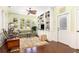 Cozy sunroom features lots of natural light, built-in bookcases, and hardwood floors at 2050 Wappoo Hall Rd, Charleston, SC 29412