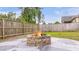 Outdoor fire pit with a stone base and a view of the fenced backyard at 209 Palmetto Walk Dr, Summerville, SC 29486