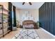 bedroom with a black accent wall, wood floors, crib, and dinosaur decor at 209 Palmetto Walk Dr, Summerville, SC 29486