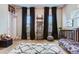Bedroom with hardwood floors, black curtains, an area rug, toys and furniture at 209 Palmetto Walk Dr, Summerville, SC 29486