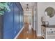 Hallway with a wooden floor and blue wall, leading to the living spaces at 209 Palmetto Walk Dr, Summerville, SC 29486