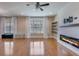 Living room with hardwood floors, a modern fireplace, and bright windows at 209 Palmetto Walk Dr, Summerville, SC 29486