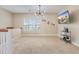 Upstairs loft area with carpet, large windows, modern light fixture, and TV with console at 209 Palmetto Walk Dr, Summerville, SC 29486
