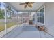 Screened-in porch featuring ceiling fan and outdoor seating, perfect for relaxing outdoors at 209 Palmetto Walk Dr, Summerville, SC 29486
