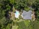 Aerial shot of a private backyard oasis, featuring a pool, tropical landscaping, and a charming home at 2225 Black Oak Court, Mount Pleasant, SC 29466