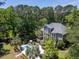 An impressive aerial view showcases the home, a pristine pool, and a serene private backyard surrounded by trees at 2225 Black Oak Court, Mount Pleasant, SC 29466