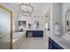 Luxurious bathroom with a soaking tub, double vanities, and elegant fixtures at 2225 Black Oak Court, Mount Pleasant, SC 29466