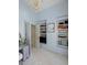 This bedroom features a walk-in closet, custom shelves, a beautiful chandelier, and a charming vanity at 2225 Black Oak Court, Mount Pleasant, SC 29466