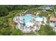 Aerial view of a resort-style pool area with lush landscaping, slides, and plenty of lounge seating at 2225 Black Oak Court, Mount Pleasant, SC 29466