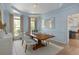Elegant dining room with wood table, stylish chairs, and soft, light blue walls at 2225 Black Oak Court, Mount Pleasant, SC 29466