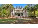 Stunning two-story home featuring a double porch and beautifully landscaped front yard with mature trees at 2225 Black Oak Court, Mount Pleasant, SC 29466