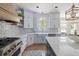 Elegant kitchen with white cabinets, a farmhouse sink, an island, and stainless steel appliances at 2225 Black Oak Court, Mount Pleasant, SC 29466