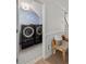 An efficient laundry room featuring modern, matching washer and dryer units and stylish blue patterned wallpaper at 2225 Black Oak Court, Mount Pleasant, SC 29466