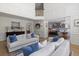 Bright living room with white sofas, blue accent pillows, hardwood floors, and access to the kitchen and second floor at 2225 Black Oak Court, Mount Pleasant, SC 29466