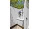 Modern outdoor shower with a white privacy screen, a sleek black shower head, and a built-in shelf at 2225 Black Oak Court, Mount Pleasant, SC 29466