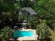 Backyard pool surrounded by palm trees and a house with a large deck for entertaining at 2225 Black Oak Court, Mount Pleasant, SC 29466