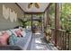 Cozy screened-in porch with comfortable seating, decor, and views of the surrounding trees at 2225 Black Oak Court, Mount Pleasant, SC 29466