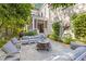 Outdoor space featuring patio, fire pit, and built-in seating under mature trees at 225 Delahow St, Daniel Island, SC 29492