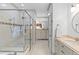 Well-lit bathroom with glass shower, neutral tile, and updated vanity at 225 Delahow St, Daniel Island, SC 29492