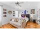 Bright bedroom features wood floors, ceiling fan and eclectic decor at 225 Delahow St, Daniel Island, SC 29492