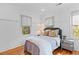 Bright bedroom showcasing hardwood floors, fresh paint, and ample natural light at 225 Delahow St, Daniel Island, SC 29492