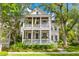 Charming two-story home with double porches, detailed railings, and vibrant landscaping at 225 Delahow St, Daniel Island, SC 29492