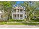 Charming two-story home featuring double porches, mature trees, and lush landscaping at 225 Delahow St, Daniel Island, SC 29492