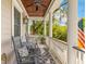 Inviting front porch featuring rocking chairs, overhead fan, and classic design at 225 Delahow St, Daniel Island, SC 29492