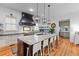 Spacious kitchen boasts a large island with counter seating and modern appliances at 225 Delahow St, Daniel Island, SC 29492