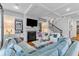 Bright living room featuring a fireplace with built-in cabinets and a staircase at 225 Delahow St, Daniel Island, SC 29492