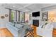 Spacious living room featuring a fireplace with built-in cabinets and coffered ceilings at 225 Delahow St, Daniel Island, SC 29492