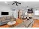 Inviting living room with hardwood floors, comfortable seating, and seamless kitchen access at 225 Delahow St, Daniel Island, SC 29492
