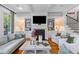 Cozy living room with a fireplace, built-in shelving, and hardwood floors at 225 Delahow St, Daniel Island, SC 29492