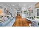 Bright living room with hardwood floors, staircase, and comfortable seating at 225 Delahow St, Daniel Island, SC 29492