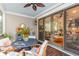 Outdoor patio features a dining table, ceiling fan, and sliding doors to the home's interior at 225 Delahow St, Daniel Island, SC 29492