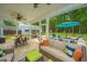 Covered back porch with ceiling fan looks out to the pool and backyard with seating and a storage shed at 229 Twin Lake Dr, Summerville, SC 29483