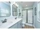 Clean and bright bathroom featuring double sinks, framed mirrors, and a sleek glass-enclosed shower at 229 Twin Lake Dr, Summerville, SC 29483