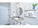 Bathroom featuring a vanity with granite countertops, round mirror, and decorative wall art at 229 Twin Lake Dr, Summerville, SC 29483