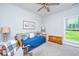 Bright bedroom features a daybed with blue cover and decorative pillows, plus a wooden chest and ceiling fan at 229 Twin Lake Dr, Summerville, SC 29483