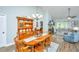 Cozy dining area with wooden table set, decorative hutch, flowing into the living room with a fireplace at 229 Twin Lake Dr, Summerville, SC 29483