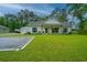 Well-maintained home featuring a lush green lawn, covered porch, and ample parking at 229 Twin Lake Dr, Summerville, SC 29483