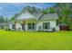 Charming single-story home featuring a covered front porch and well-maintained lawn at 229 Twin Lake Dr, Summerville, SC 29483