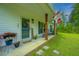 Cozy front porch featuring a welcome sign, rocking chairs, and vibrant potted flowers at 229 Twin Lake Dr, Summerville, SC 29483