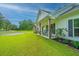 Charming front porch with rocking chairs, flowers, and a well-manicured lawn at 229 Twin Lake Dr, Summerville, SC 29483