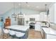 Modern kitchen features stainless appliances, white cabinetry and backsplash, plus a large island with barstool seating at 229 Twin Lake Dr, Summerville, SC 29483