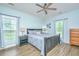 Bright and serene main bedroom with large windows, ceiling fan, and modern furnishings, offering a peaceful retreat at 229 Twin Lake Dr, Summerville, SC 29483